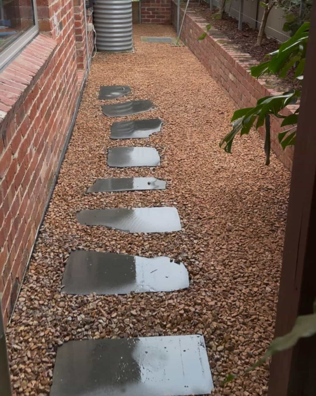 Stepping-stone side path in Templestowe Lower set into decorative gravel between the brick house and raised garden bed