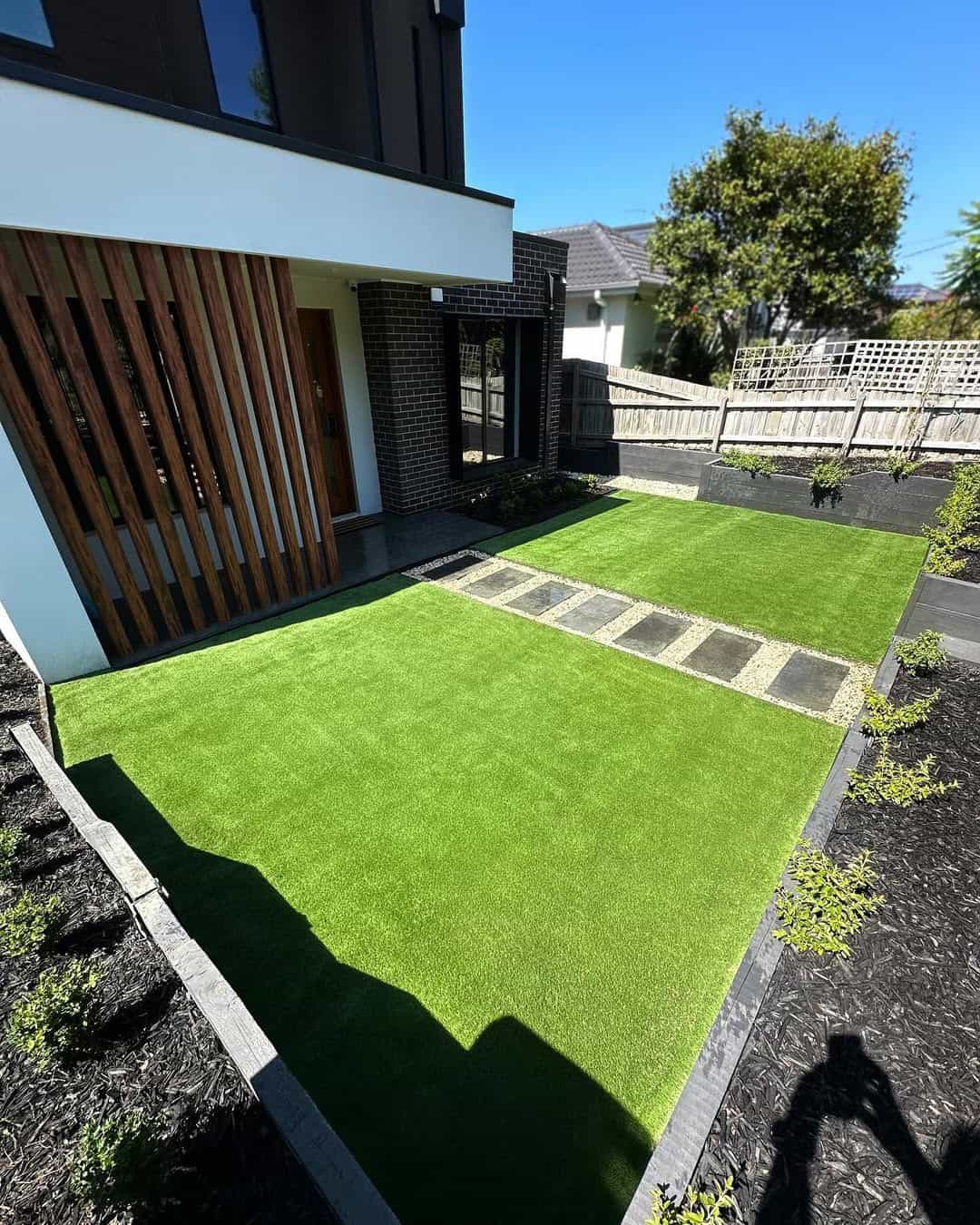 Artificial grass installation in Melbourne backyard landscaping project